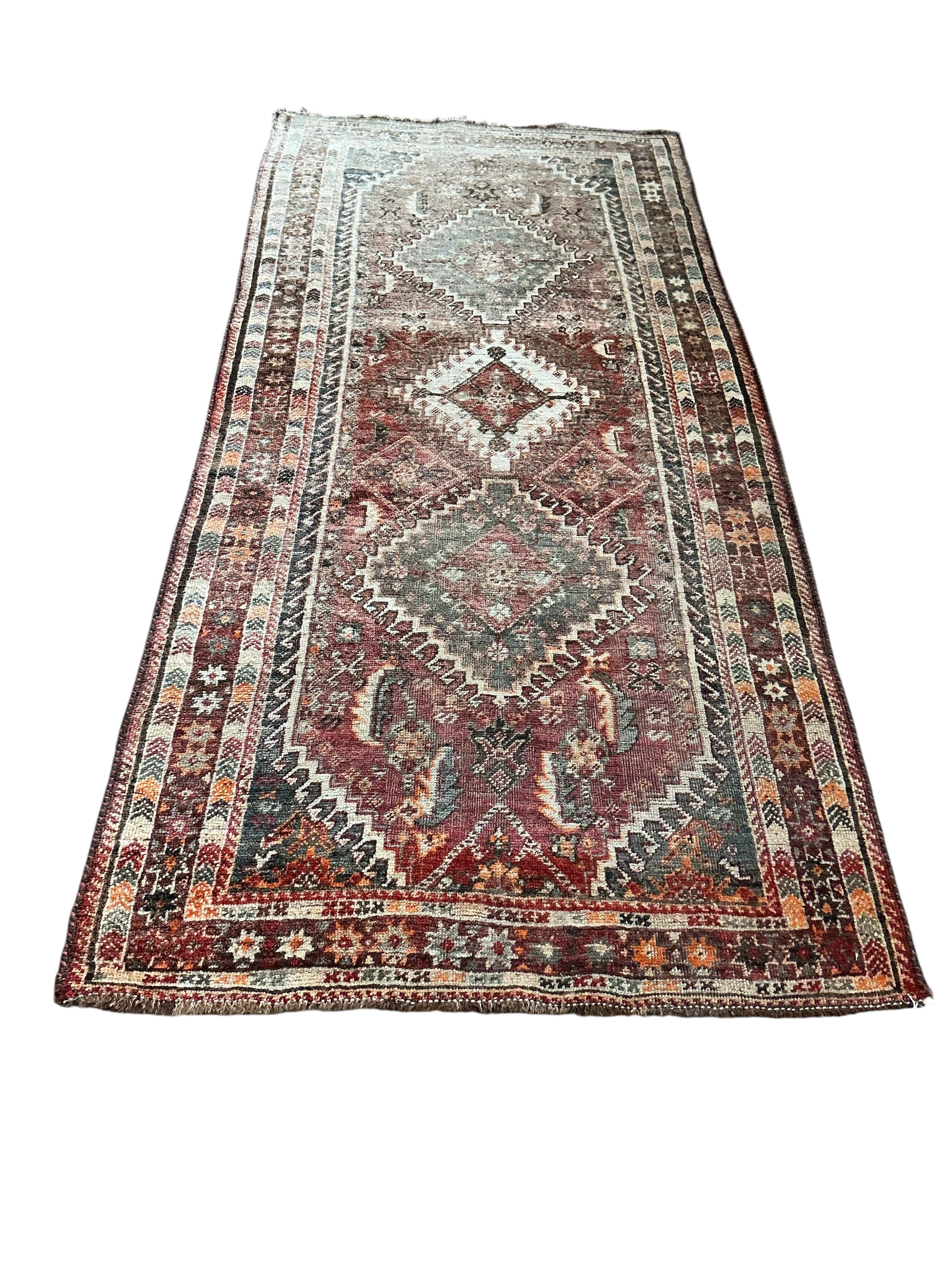 A Hamadan red ground rug, some sun fading, 220 x 105cm